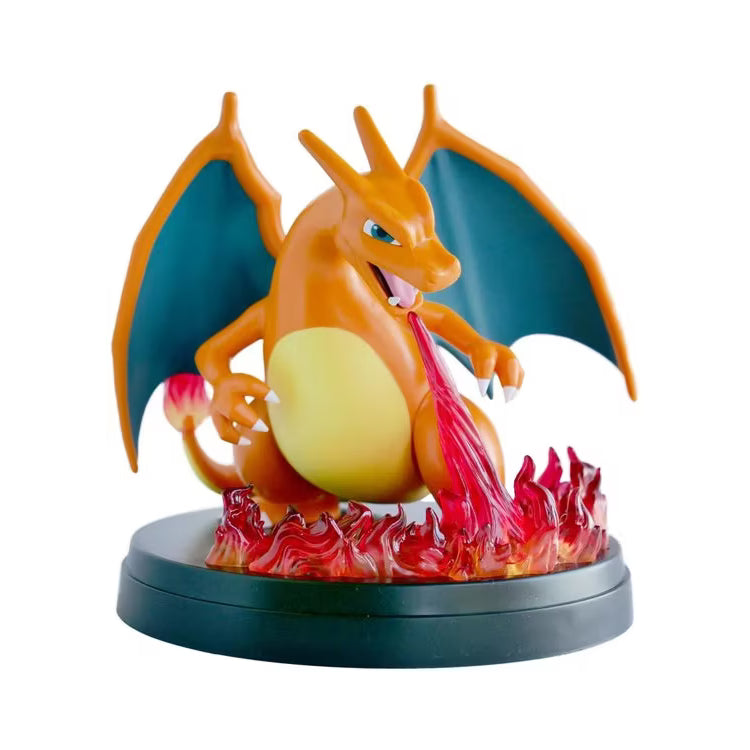 The Pokémon TCG: Charizard ex Super-Premium Collection by The Pokémon Company features a Charizard figure standing on a black base, breathing fire with flames around its feet, wings spread wide, and a flame at the tip of its tail.