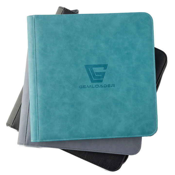 Three Gemloader: Premium Semi-Rigid Samlemappe [168 pockets 2X3] binders are stacked, with a teal Gemloader binder on top, ideal for grading kort or use as a samlemappe. The binders below are gray and black.