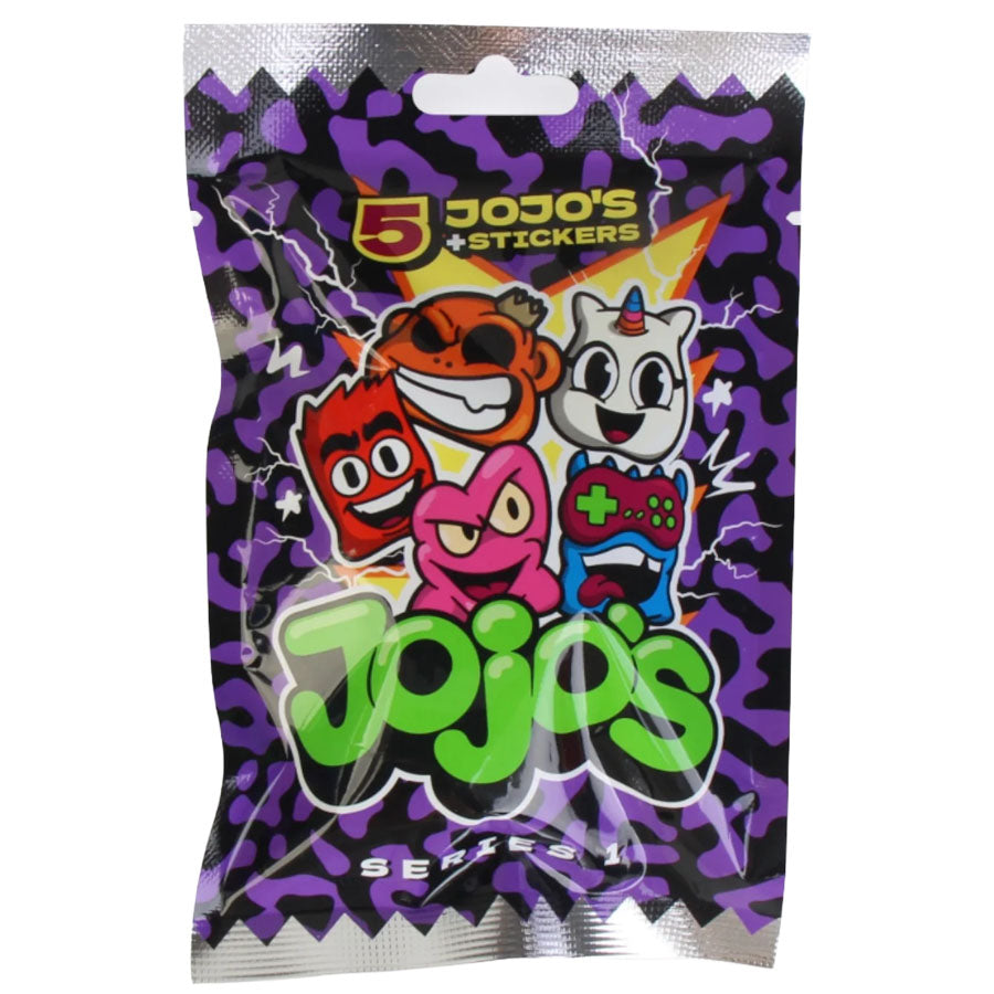 A purple and black packet labeled First Grade: Jojo’s 5 Pack - Series 1 from the brand FirstGrade features cartoon faces of a red character, a brown bear, a pink creature, and a white unicorn holding a game controller. This overraskelsespakke is perfect for First Grade kids and states it contains 5 stickers.