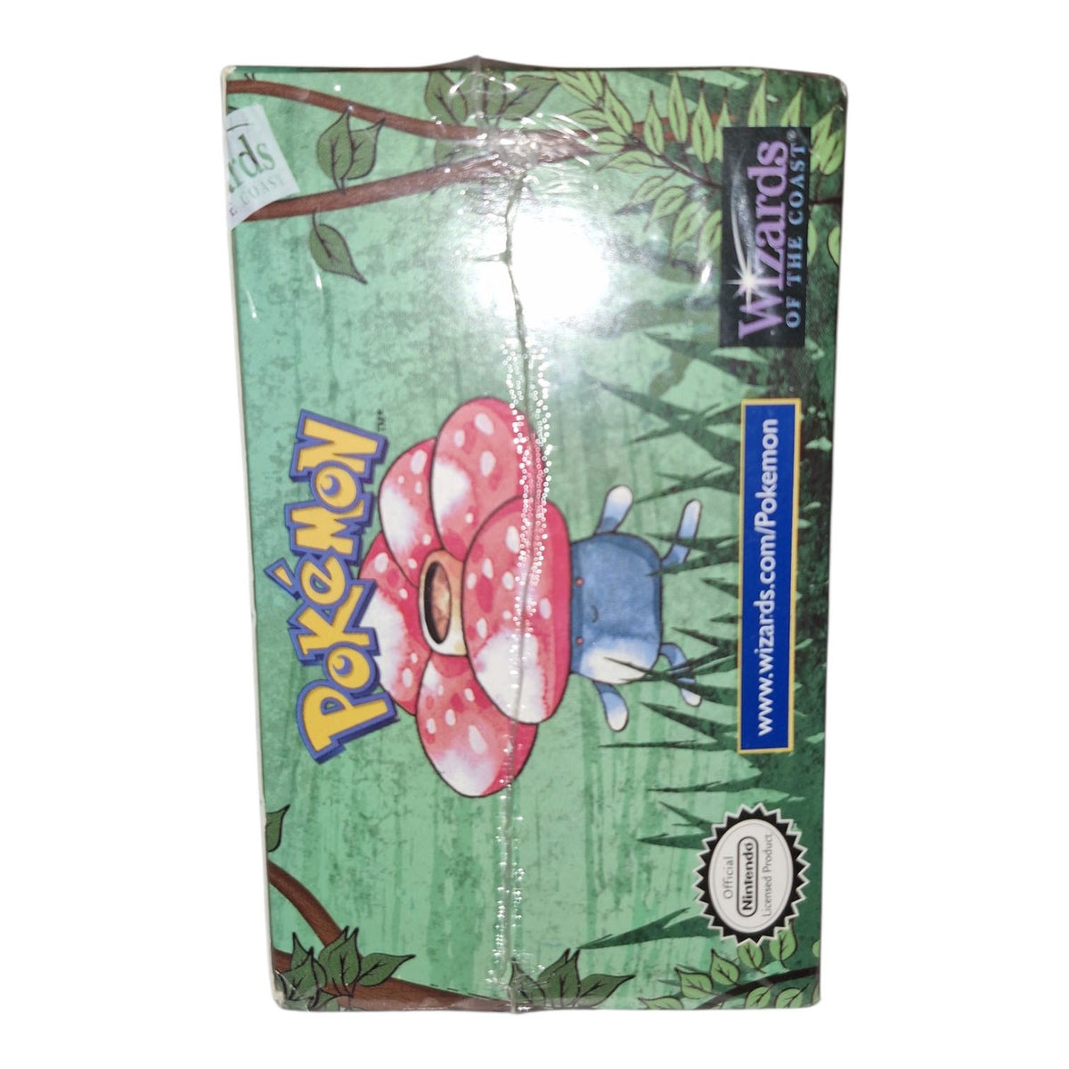 The Pokémon TCG: Jungle Booster Box - 1st Edition by The Pokémon Company features Vileplume on a green leafy background, plus the Pokémon logo and a Wizards of the Coast label on the side.